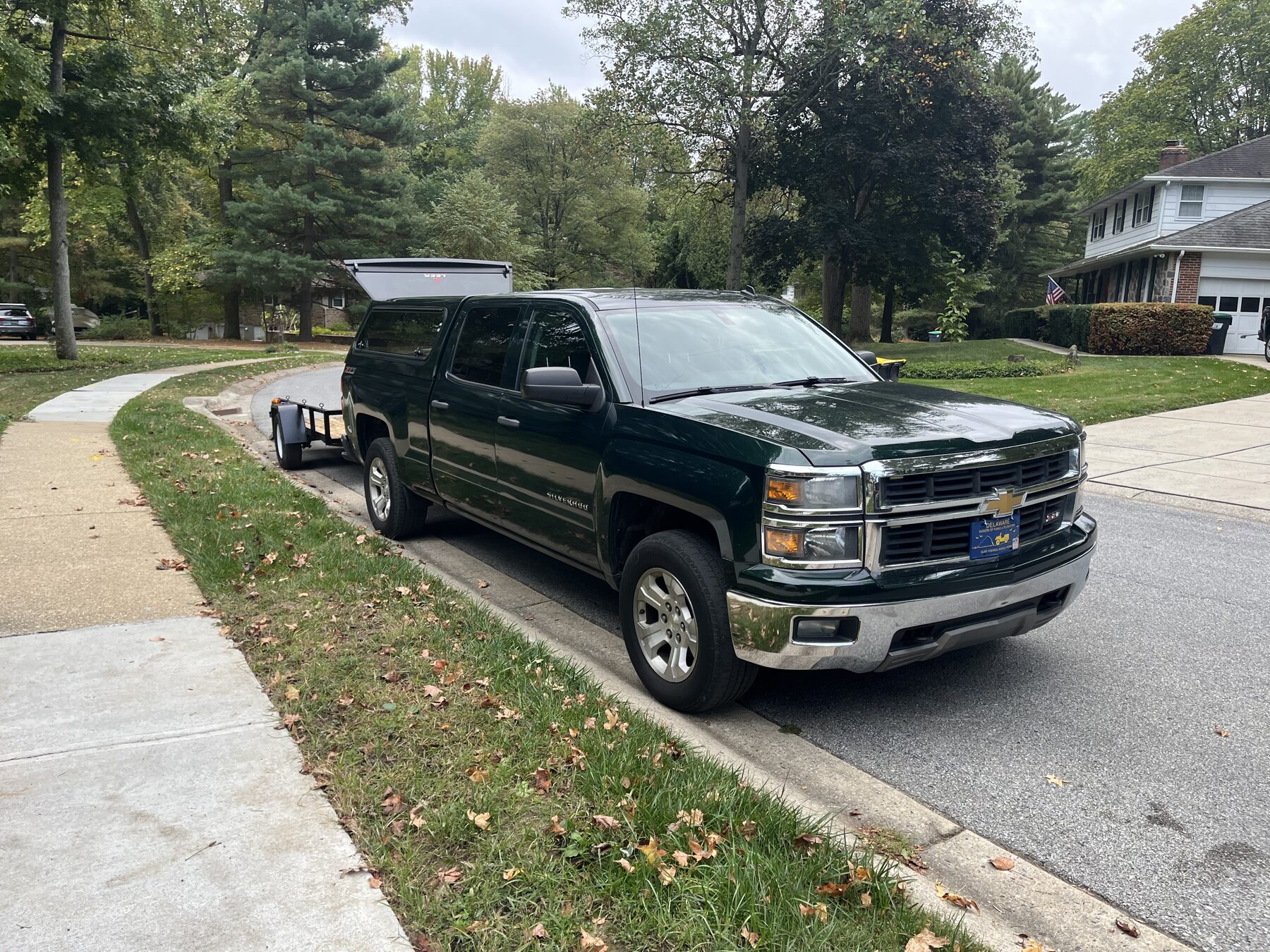 Truck and trailer parked in a driveway, ready for the job